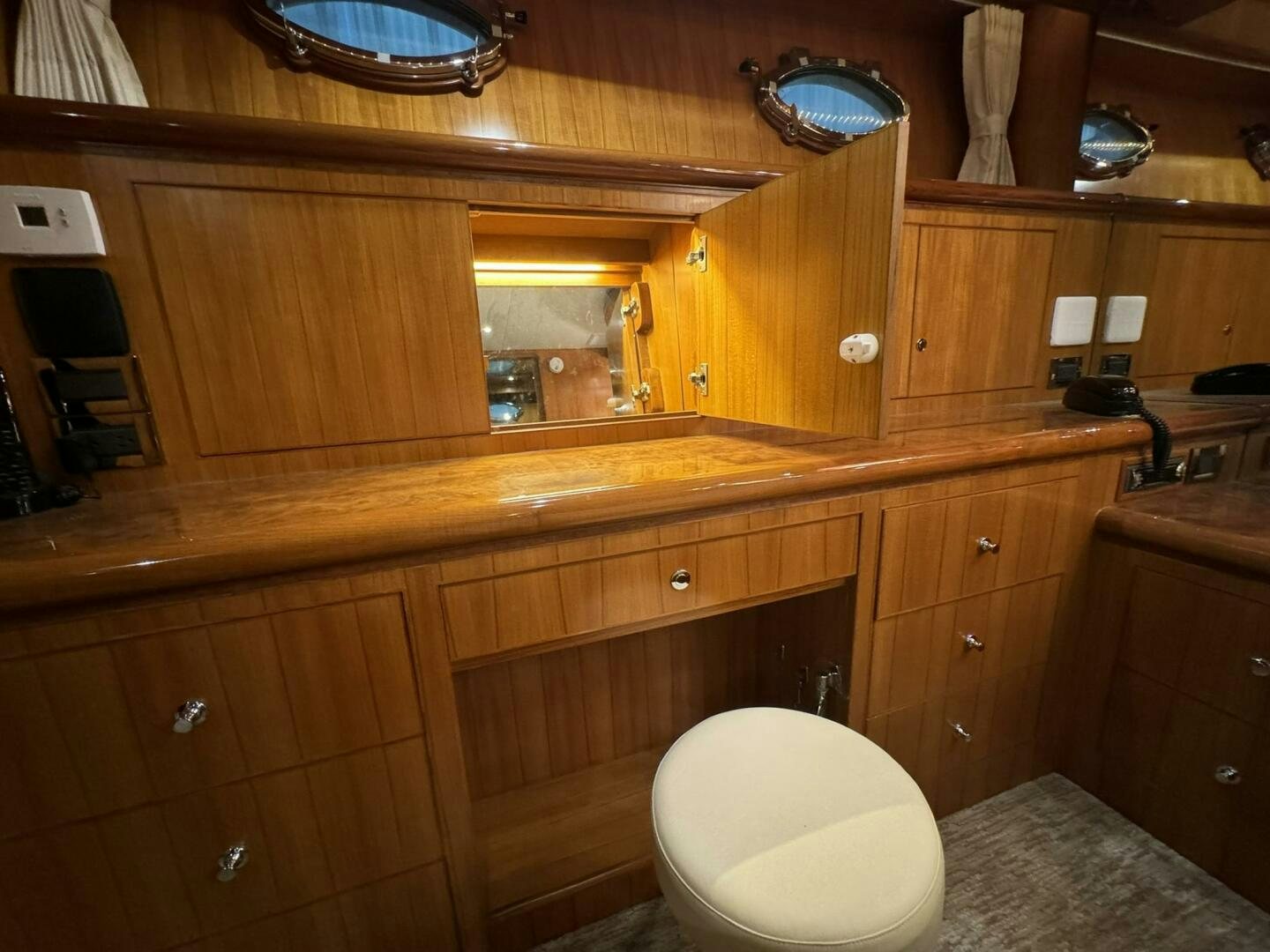 a bathroom with wooden cabinets aboard ALL ABORDEAUX Yacht for Sale
