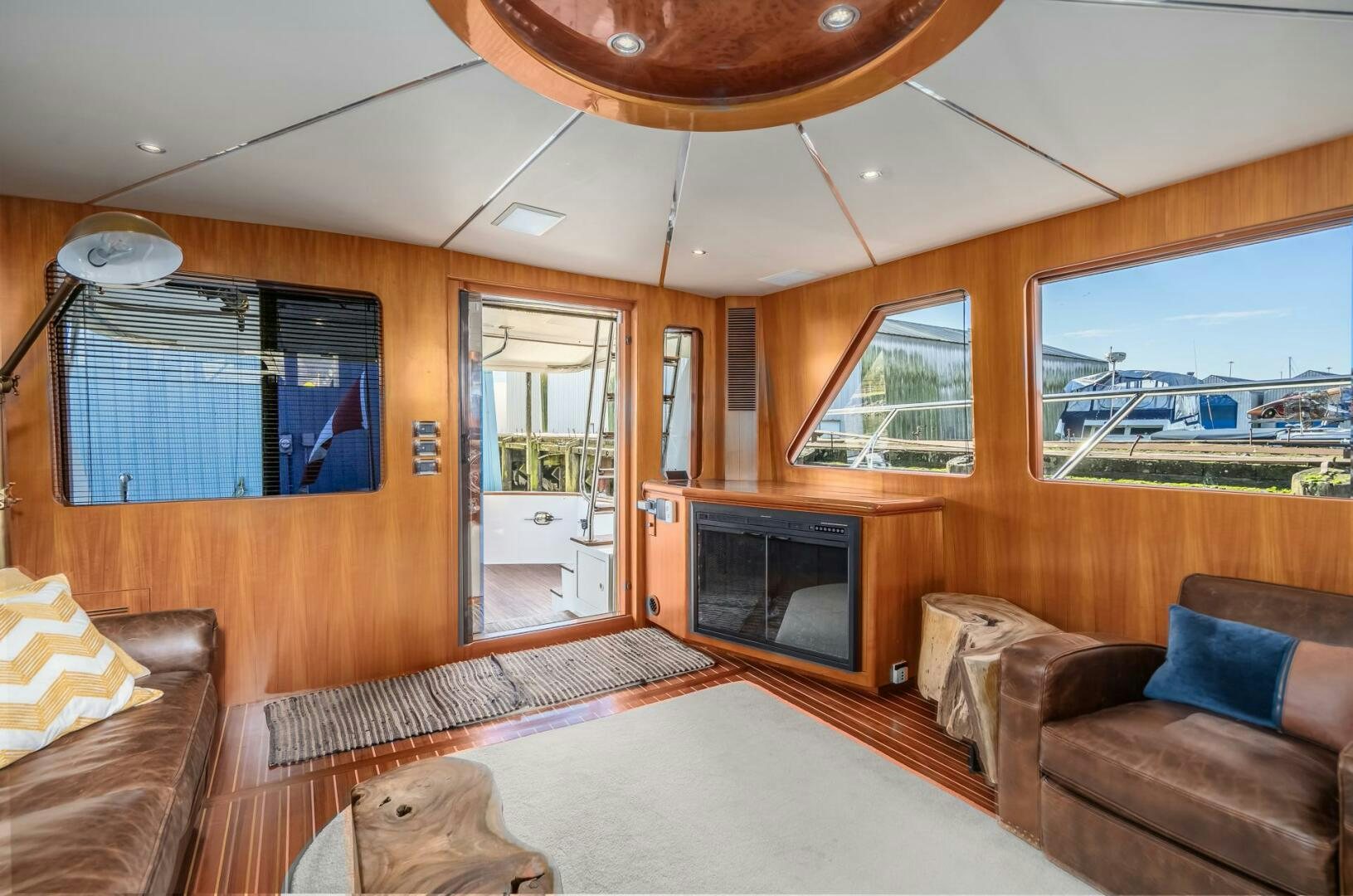 a living room with a fireplace aboard ALL ABORDEAUX Yacht for Sale