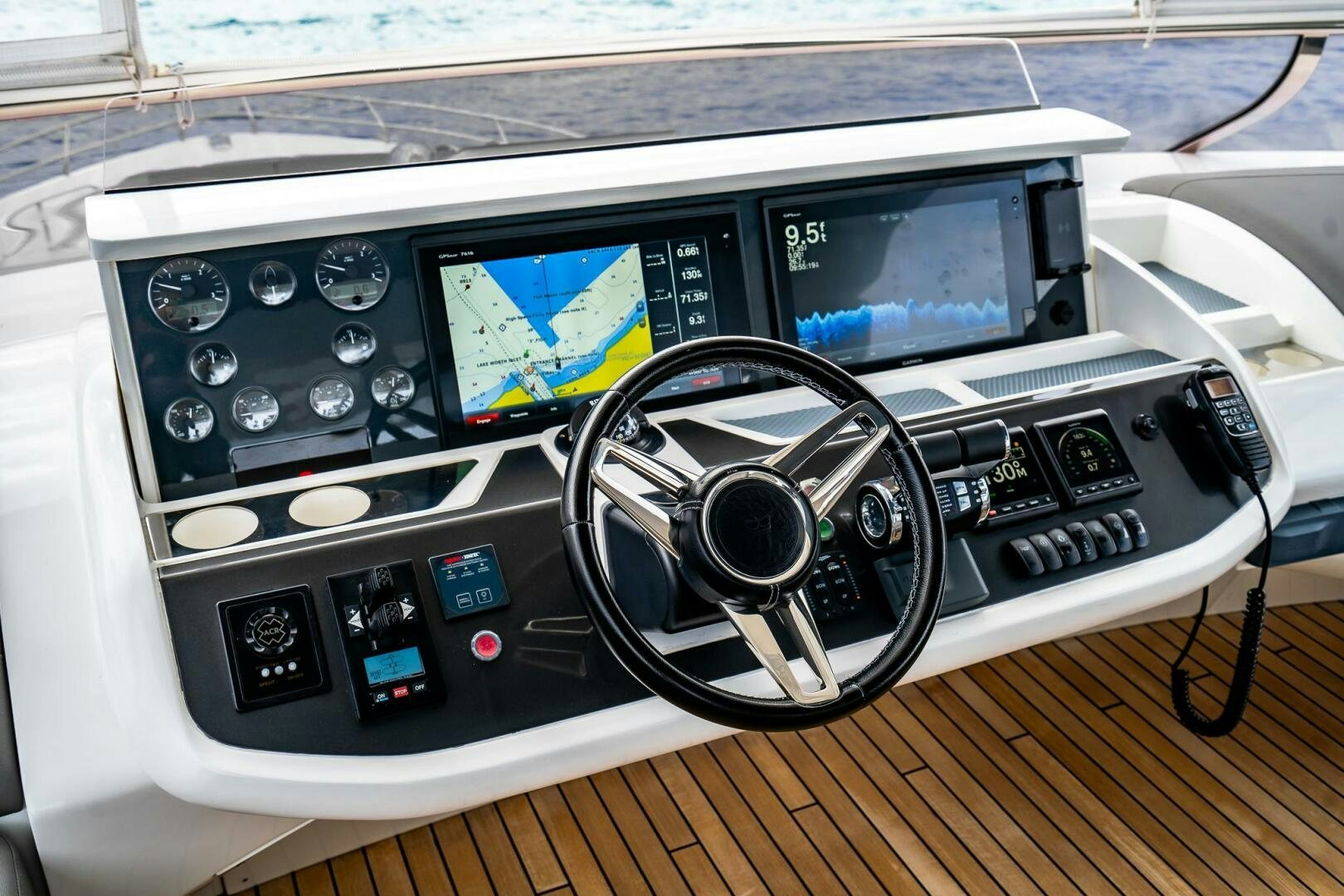 a car stereo with a screen and a steering wheel aboard PERFECT MATCH Yacht for Sale