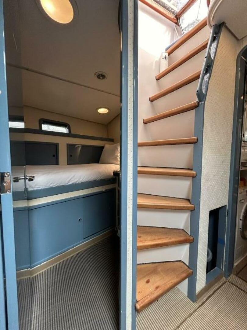 a bunk bed with a wood frame aboard TOTO Yacht for Sale