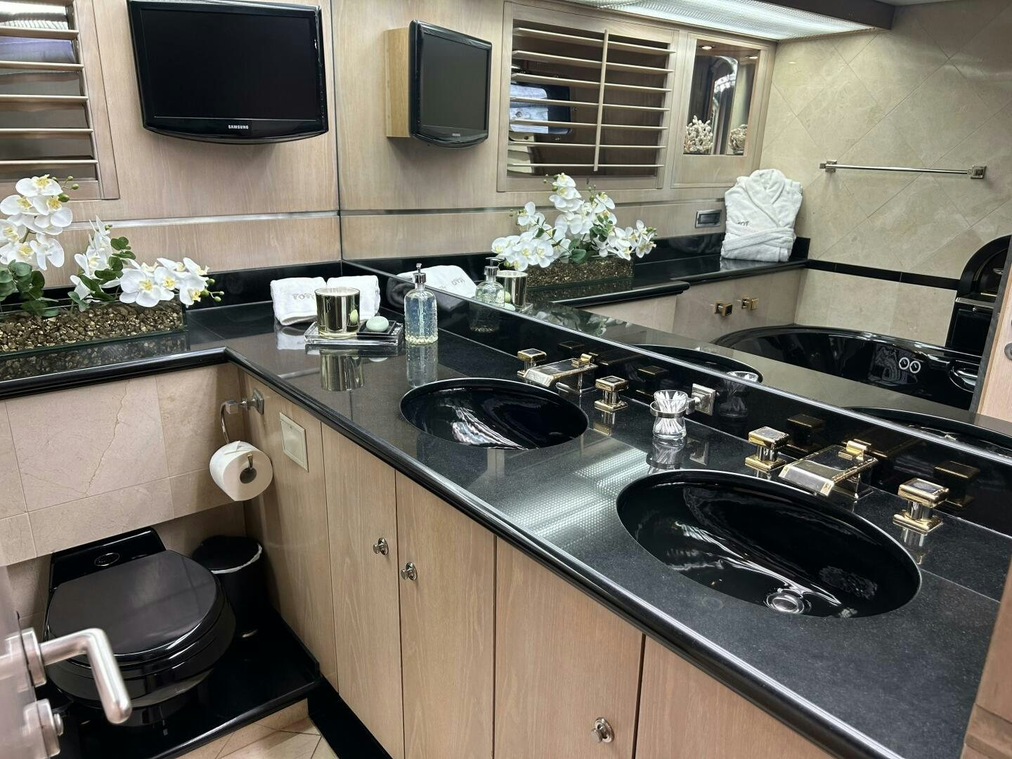 a kitchen with black counter tops aboard TOTO Yacht for Sale