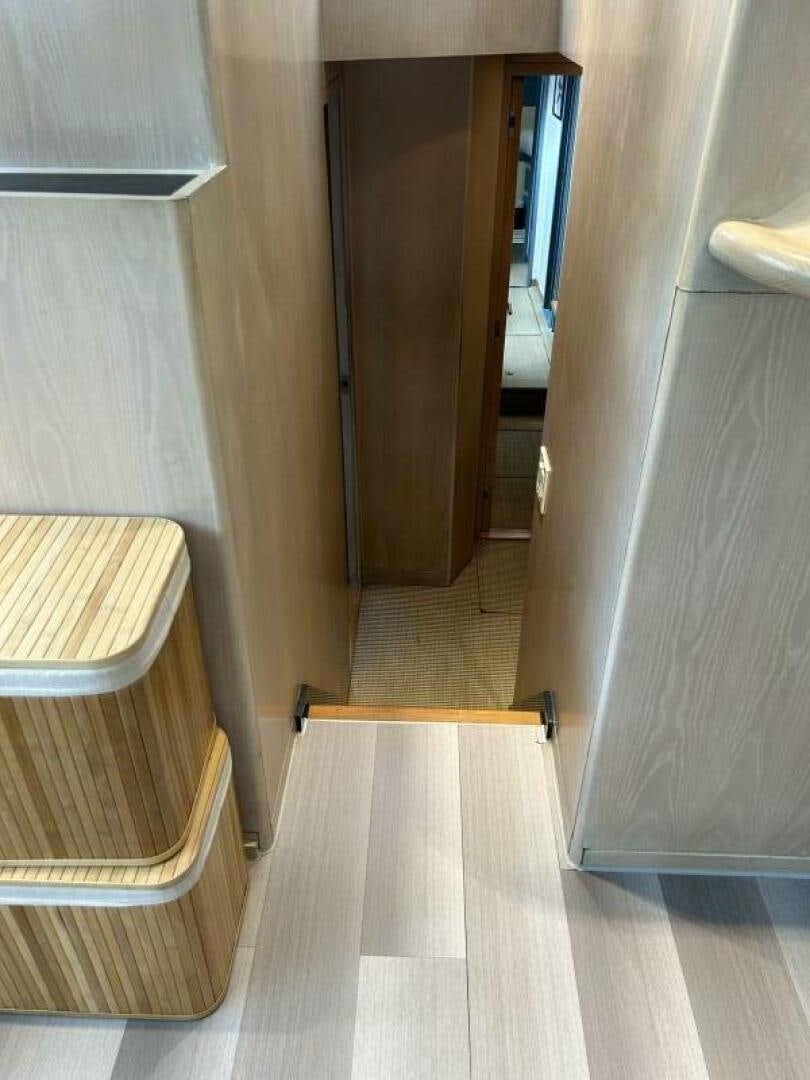 a hallway with a wood door aboard TOTO Yacht for Sale