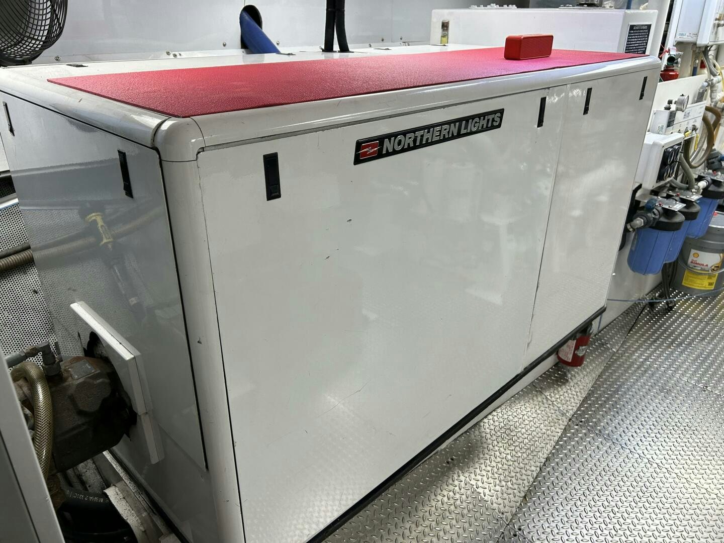 a white machine with a red and black label aboard TOTO Yacht for Sale