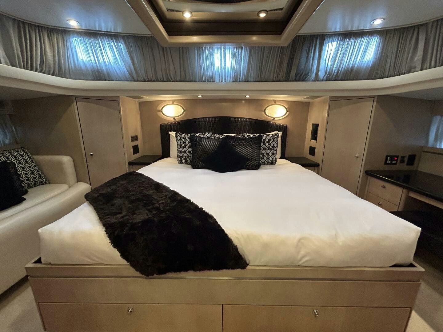 a bed with white sheets aboard TOTO Yacht for Sale