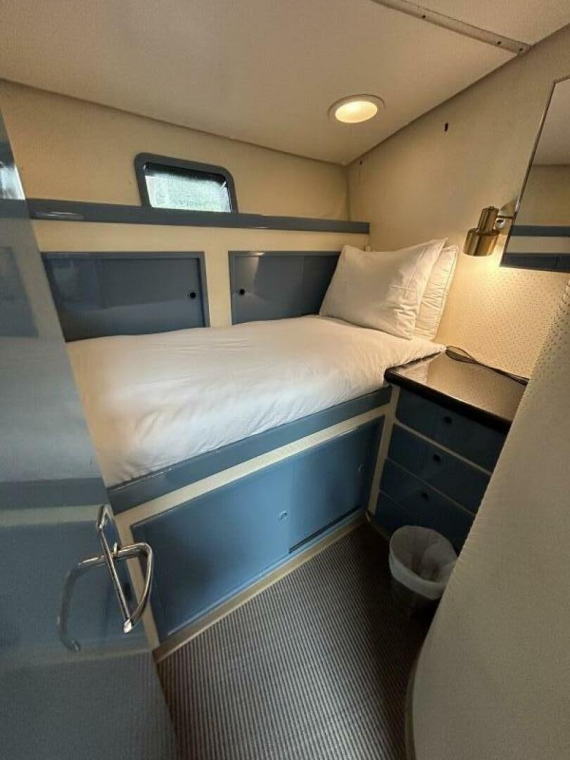 a bed with a white sheet aboard TOTO Yacht for Sale