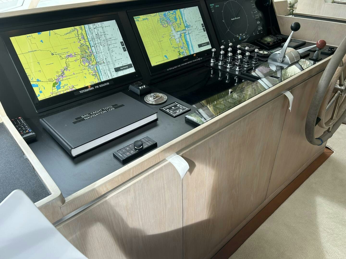 a desk with a computer and a monitor on it aboard TOTO Yacht for Sale