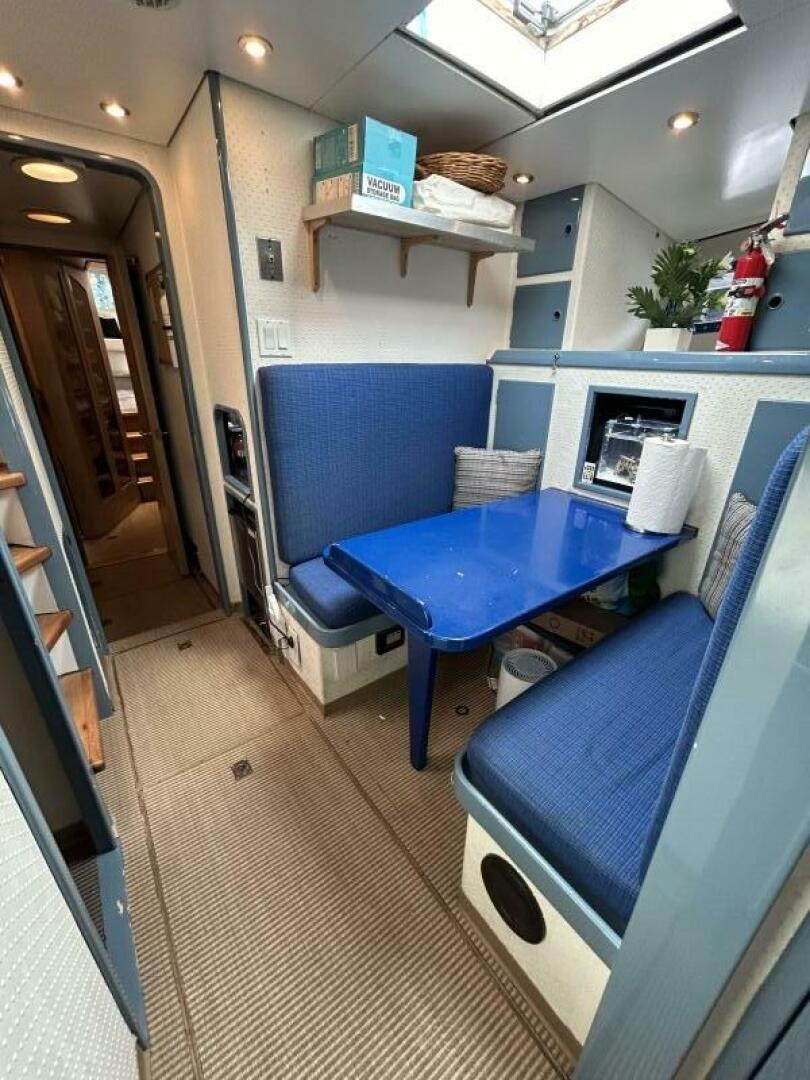 a kitchen with a blue chair aboard TOTO Yacht for Sale