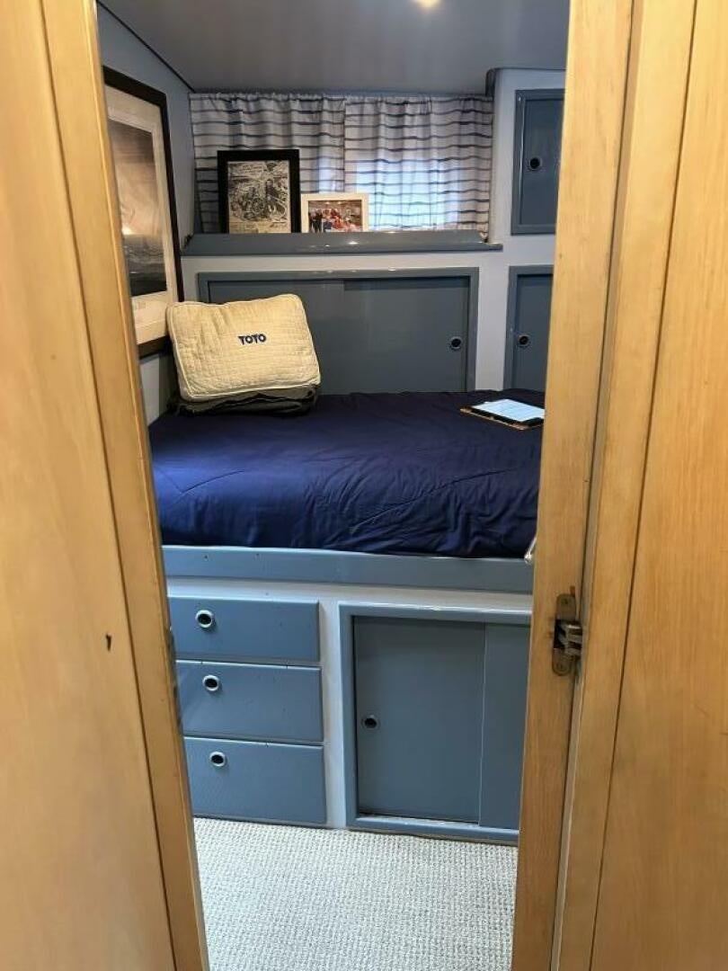 a bedroom with a bed and a desk aboard TOTO Yacht for Sale
