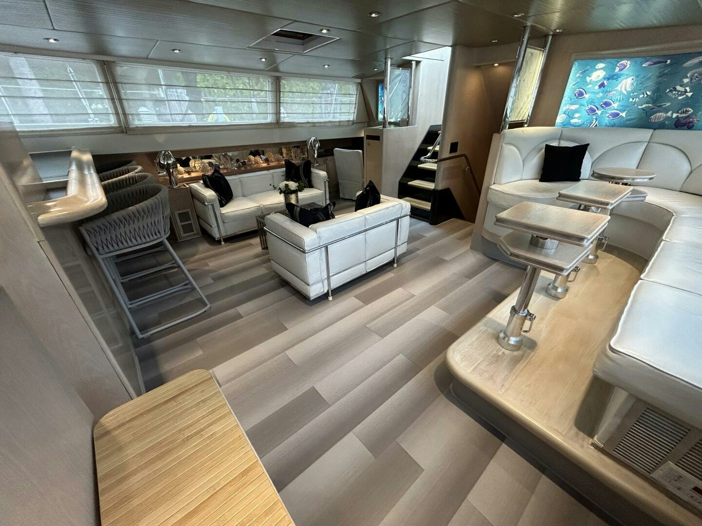 a room with a few people sitting in it aboard TOTO Yacht for Sale