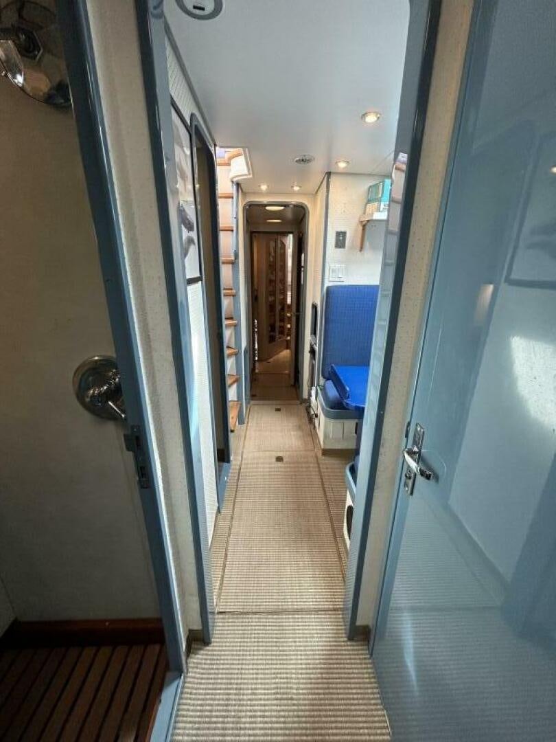 a hallway with a door and a hallway aboard TOTO Yacht for Sale