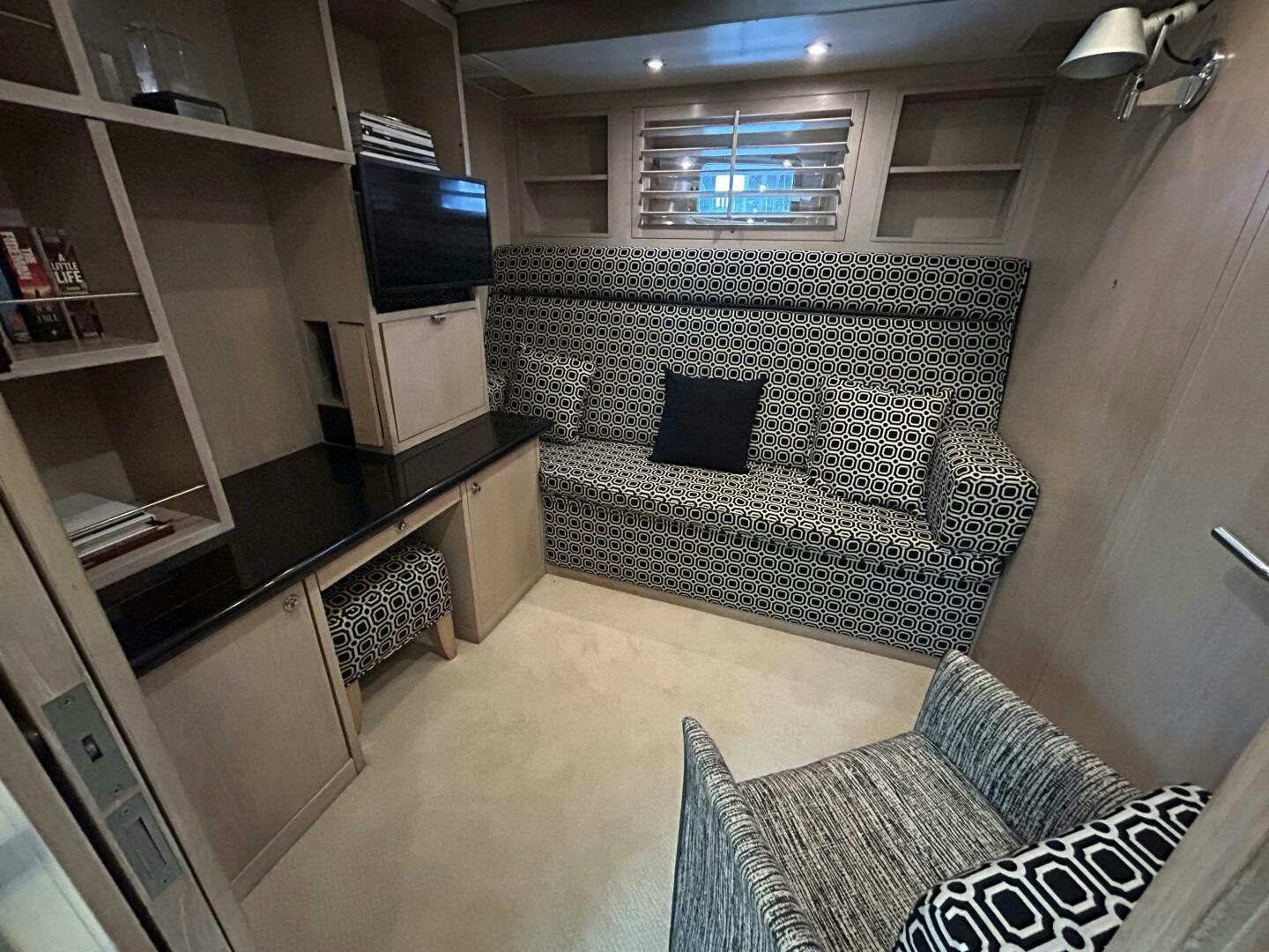 a room with a couch and a tv aboard TOTO Yacht for Sale
