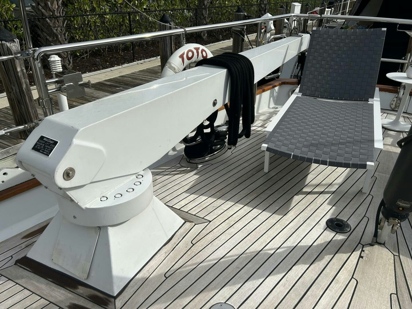 a white toilet on a deck aboard TOTO Yacht for Sale