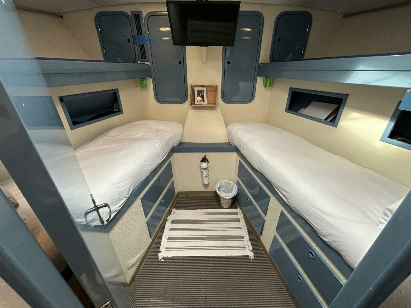a room with a bed and a table aboard TOTO Yacht for Sale