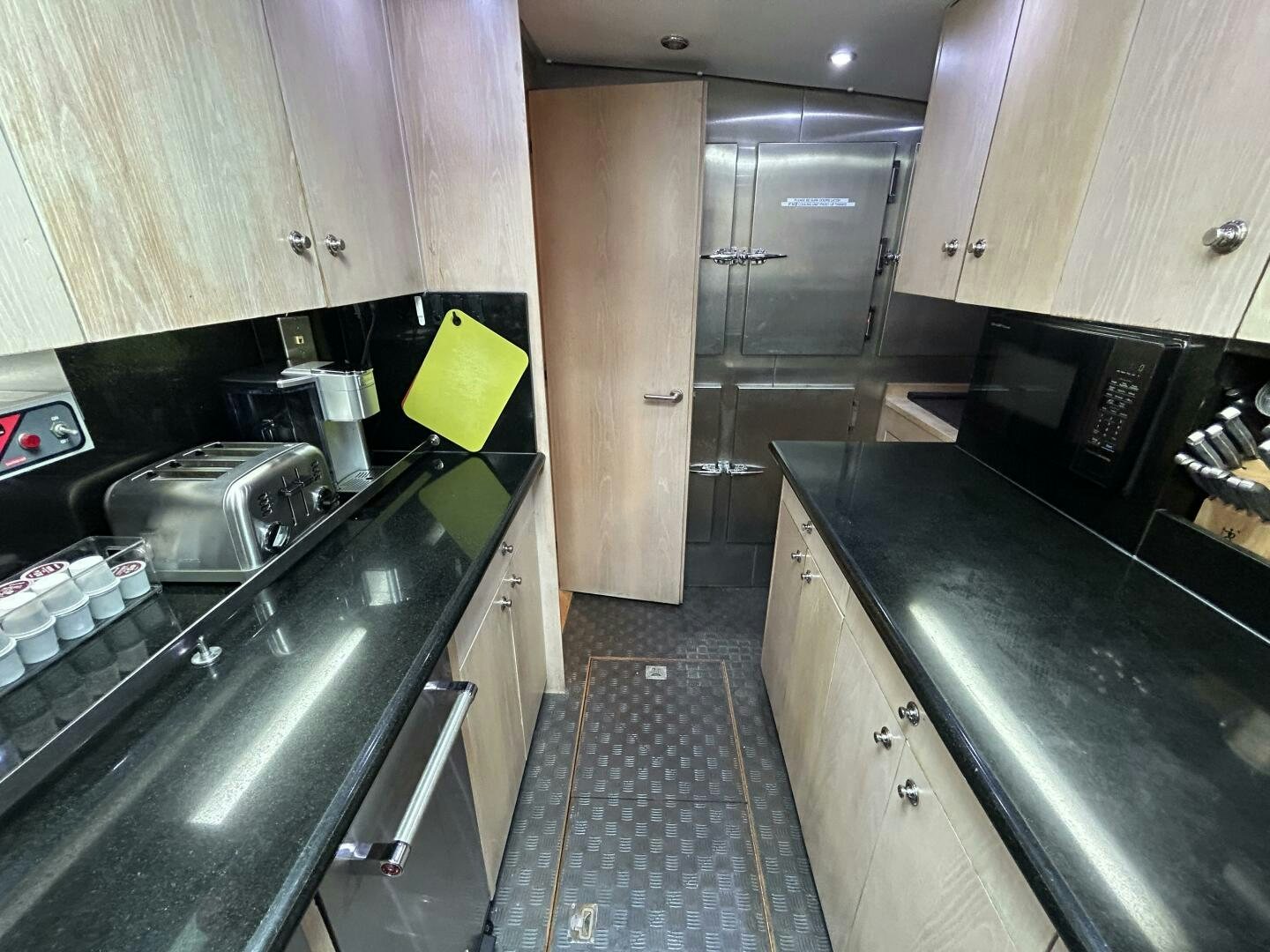 a kitchen with a black counter top aboard TOTO Yacht for Sale