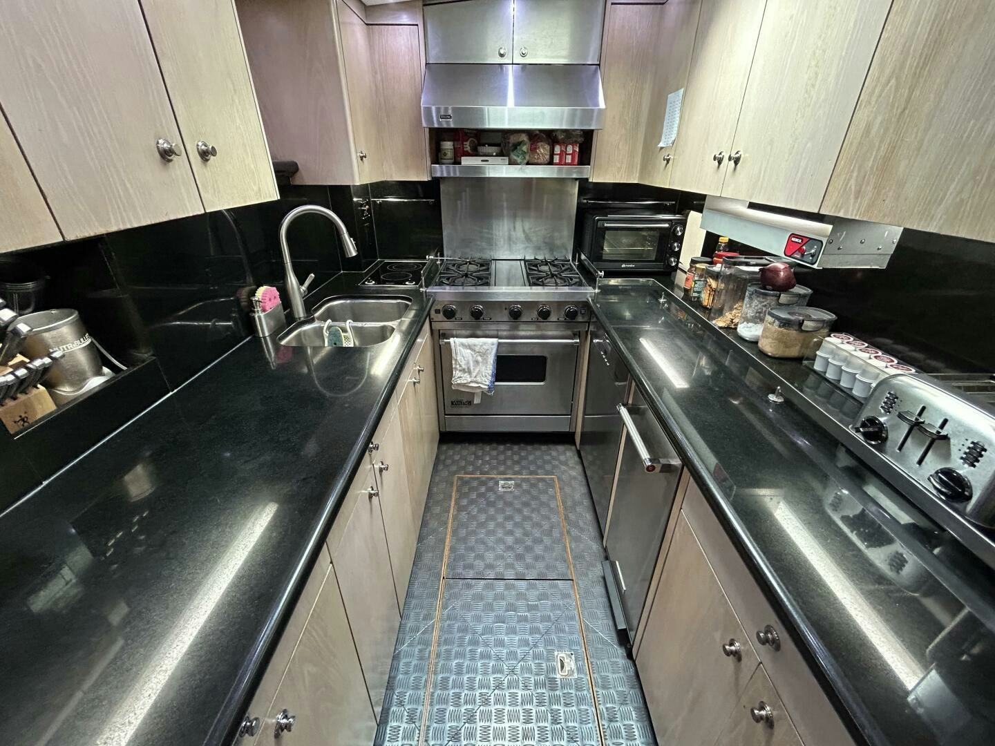 a kitchen with stainless steel appliances aboard TOTO Yacht for Sale