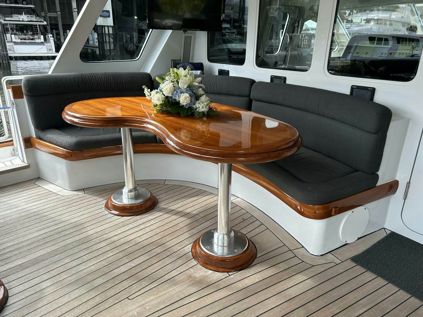 a coffee table on a deck aboard TOTO Yacht for Sale