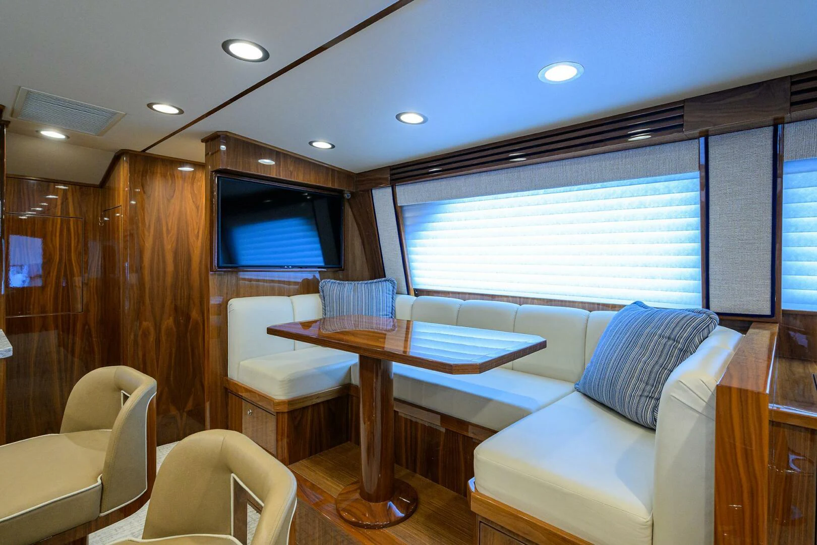 a room with a couch and a table and chairs aboard TAMI ANN Yacht for Sale