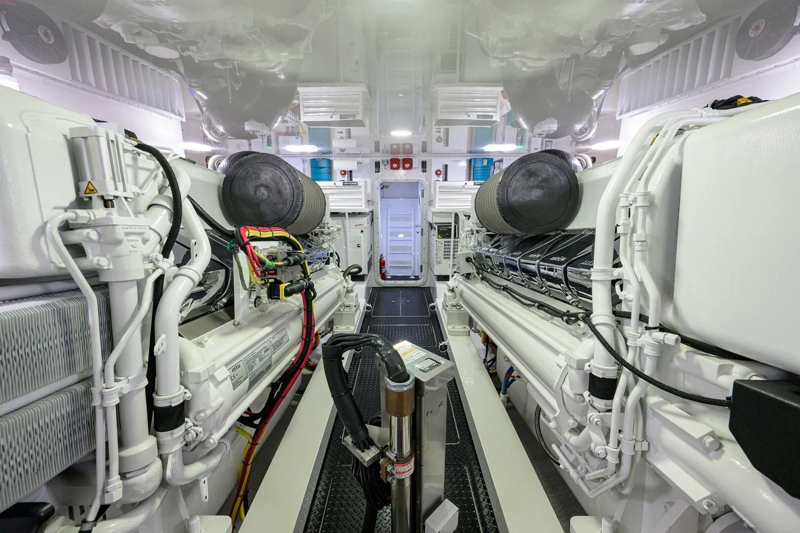 a large white room with many pipes aboard TAMI ANN Yacht for Sale
