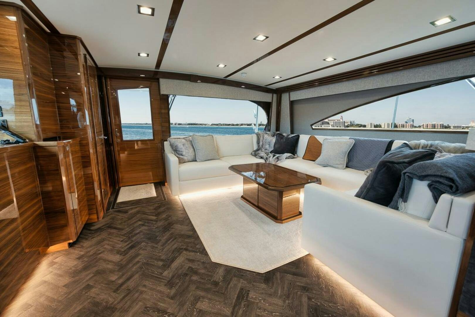 a living room with a couch and a coffee table aboard LUCKY DICK Yacht for Sale