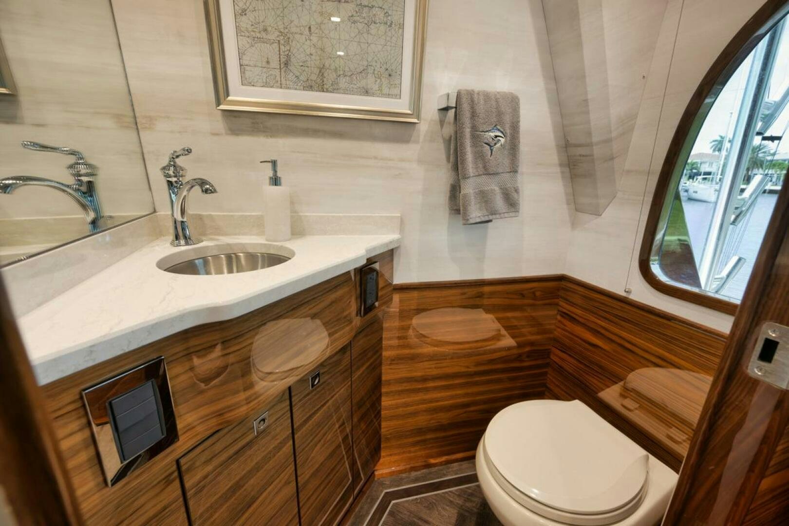 a bathroom with a sink toilet and a mirror aboard LUCKY DICK Yacht for Sale