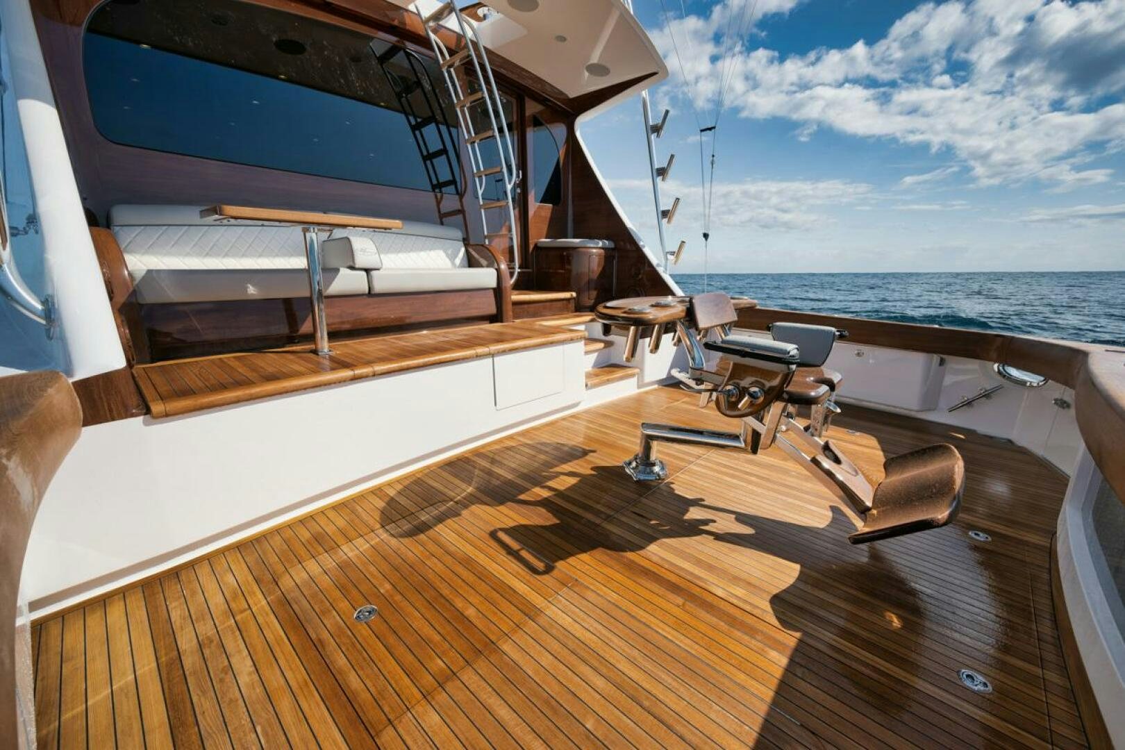 a deck with a large boat on it and a large body of water in the background aboard LUCKY DICK Yacht for Sale