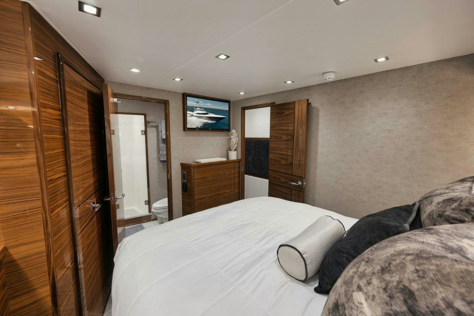 a bedroom with a bed and a closet aboard LUCKY DICK Yacht for Sale