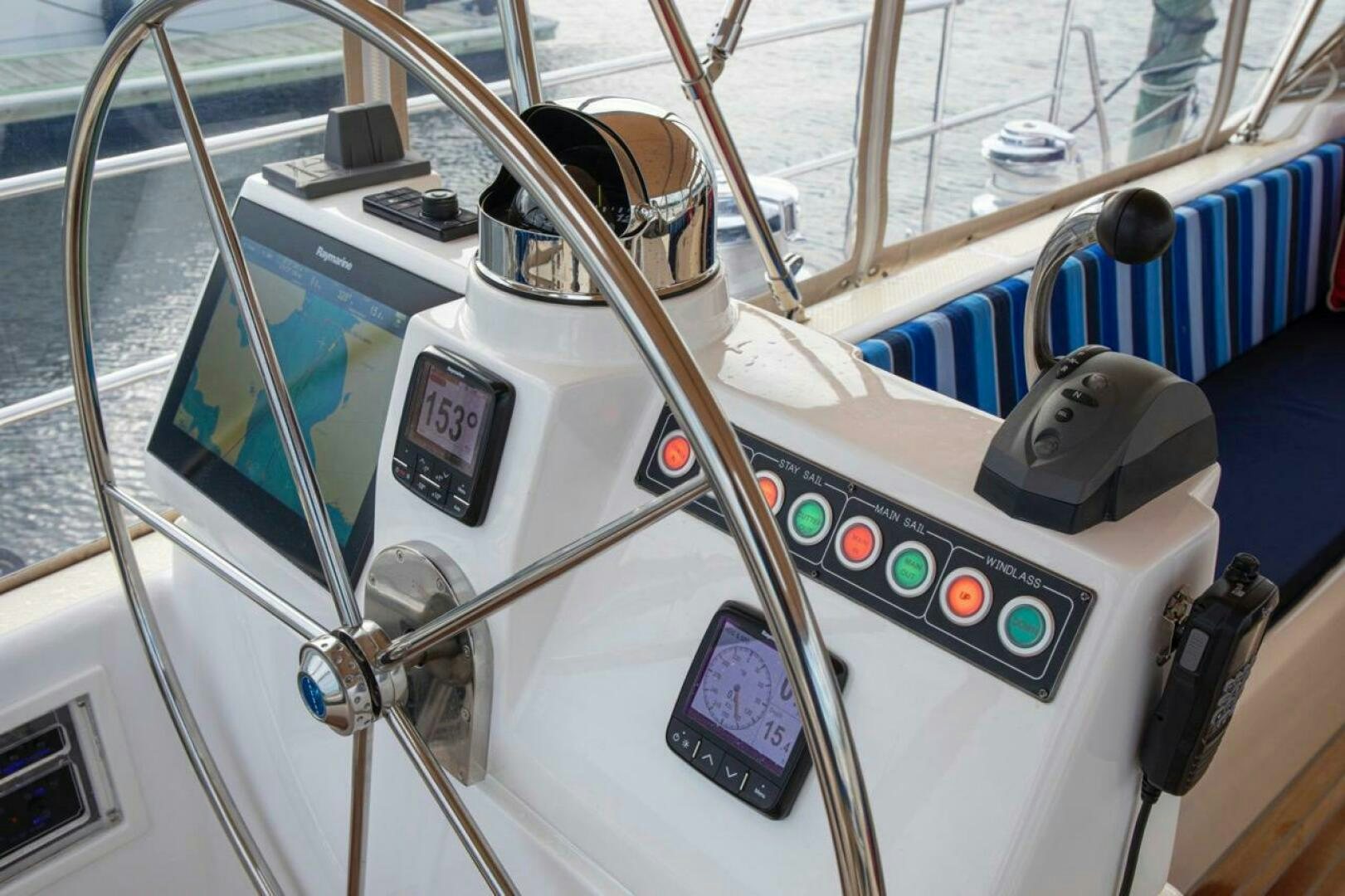 a steering wheel and dashboard of a boat aboard INDEPEPDENCE Yacht for Sale
