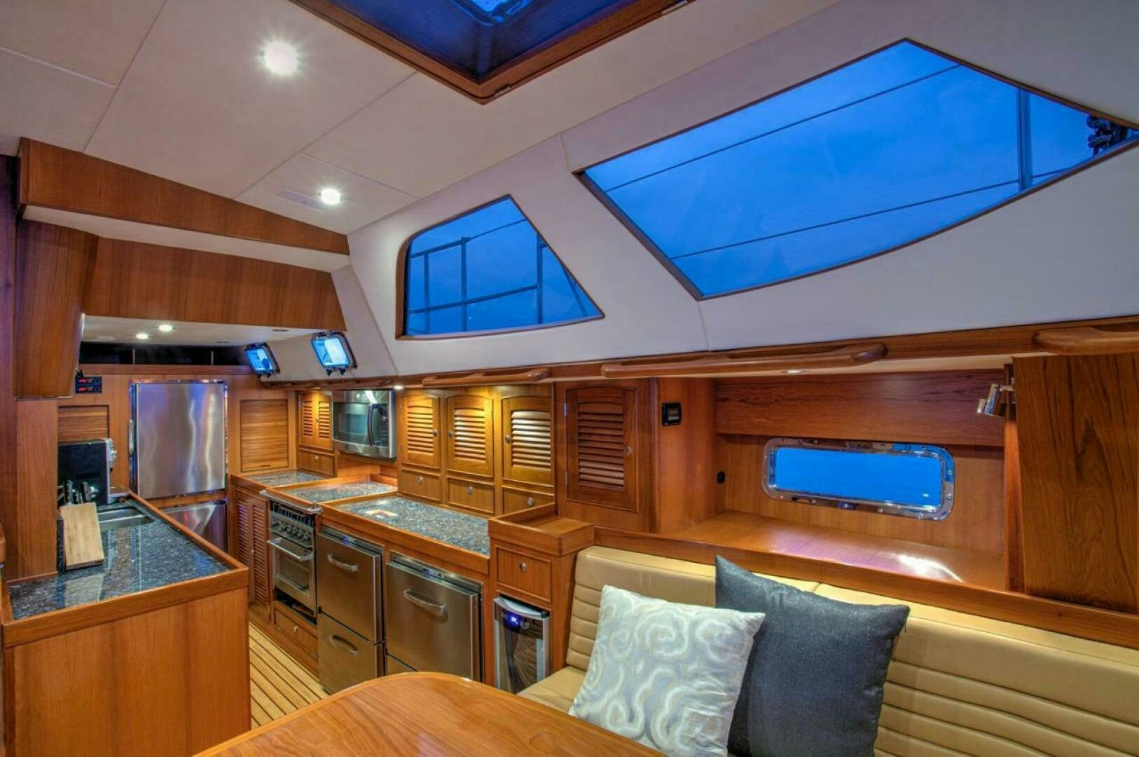 a kitchen with wooden cabinets aboard INDEPEPDENCE Yacht for Sale