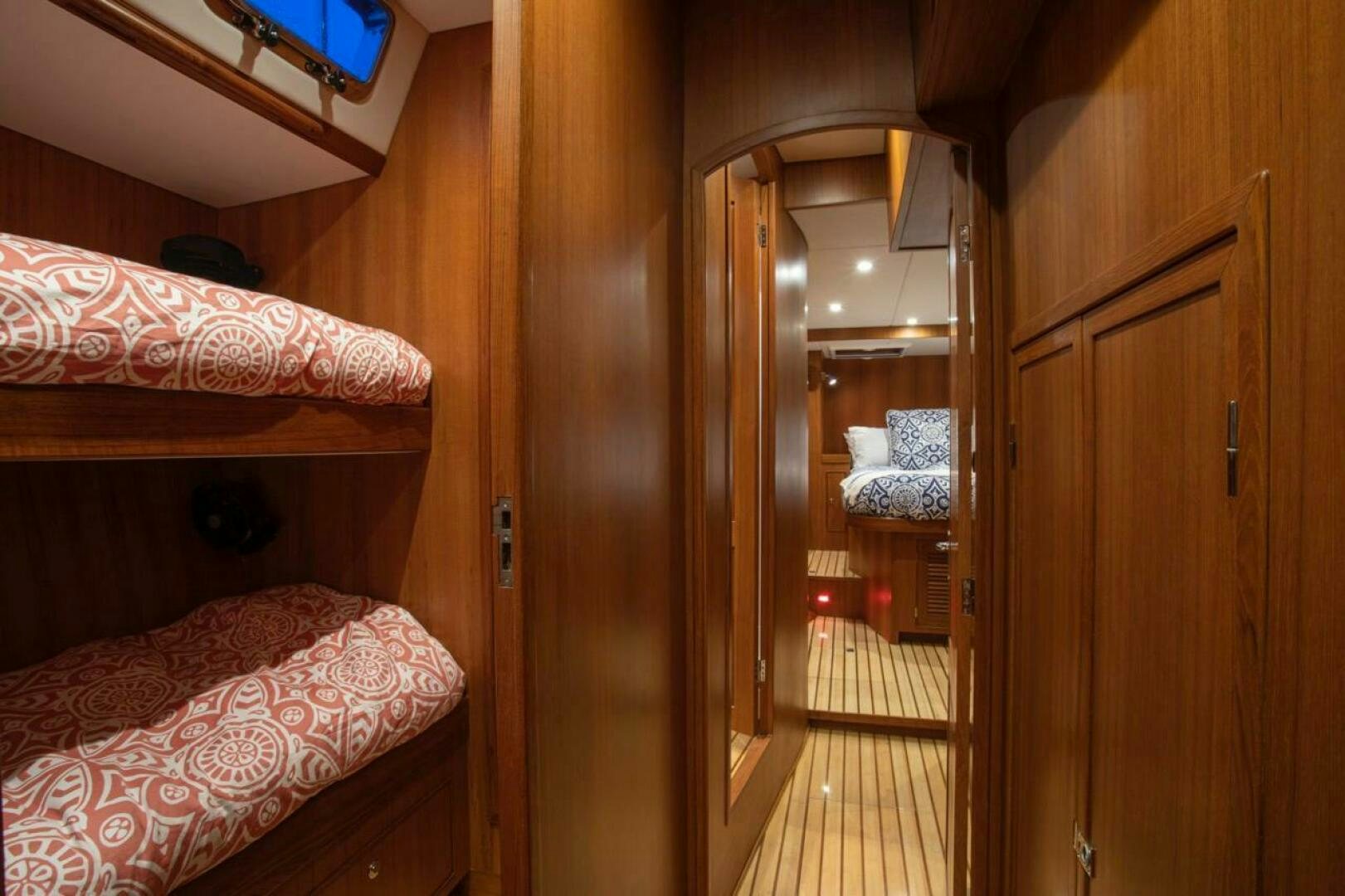 a bedroom with a bed and a closet aboard INDEPEPDENCE Yacht for Sale