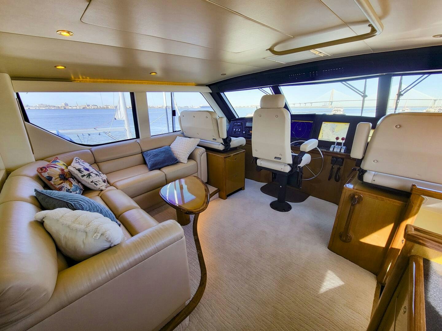 a room with a couch and a table and a chair aboard PRIME TIME Yacht for Sale