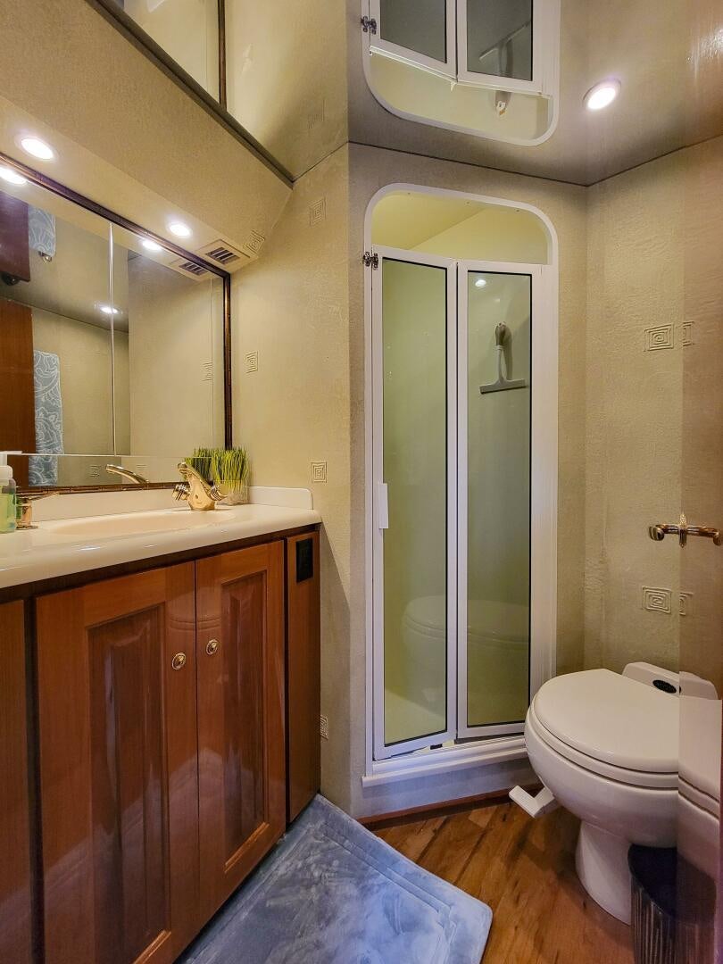 a bathroom with a glass shower door aboard PRIME TIME Yacht for Sale