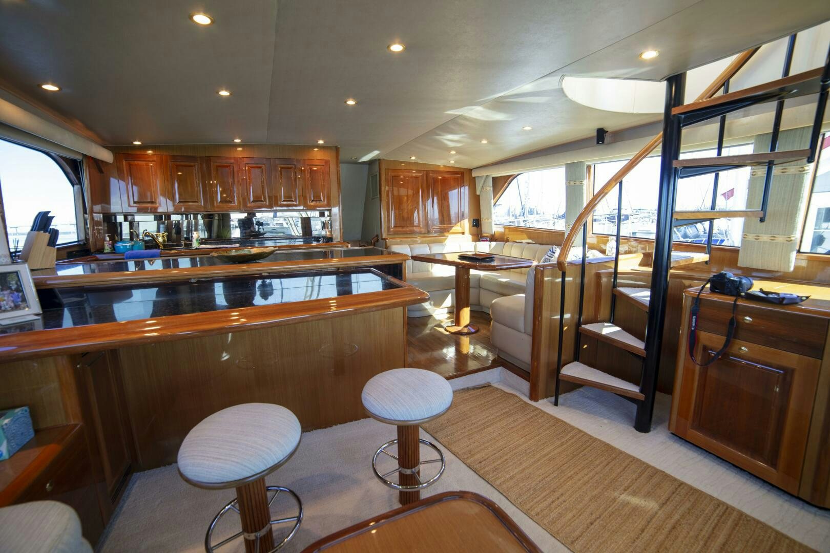 a large room with wooden cabinets aboard PRIME TIME Yacht for Sale