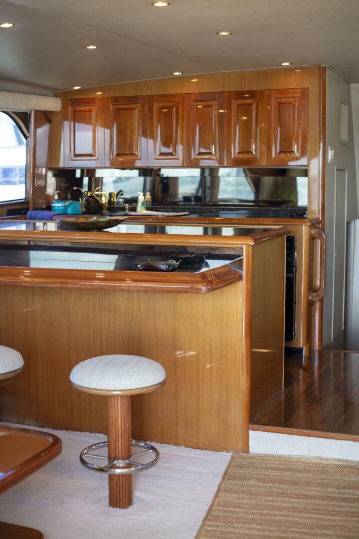 a kitchen with a stool and a stool aboard PRIME TIME Yacht for Sale