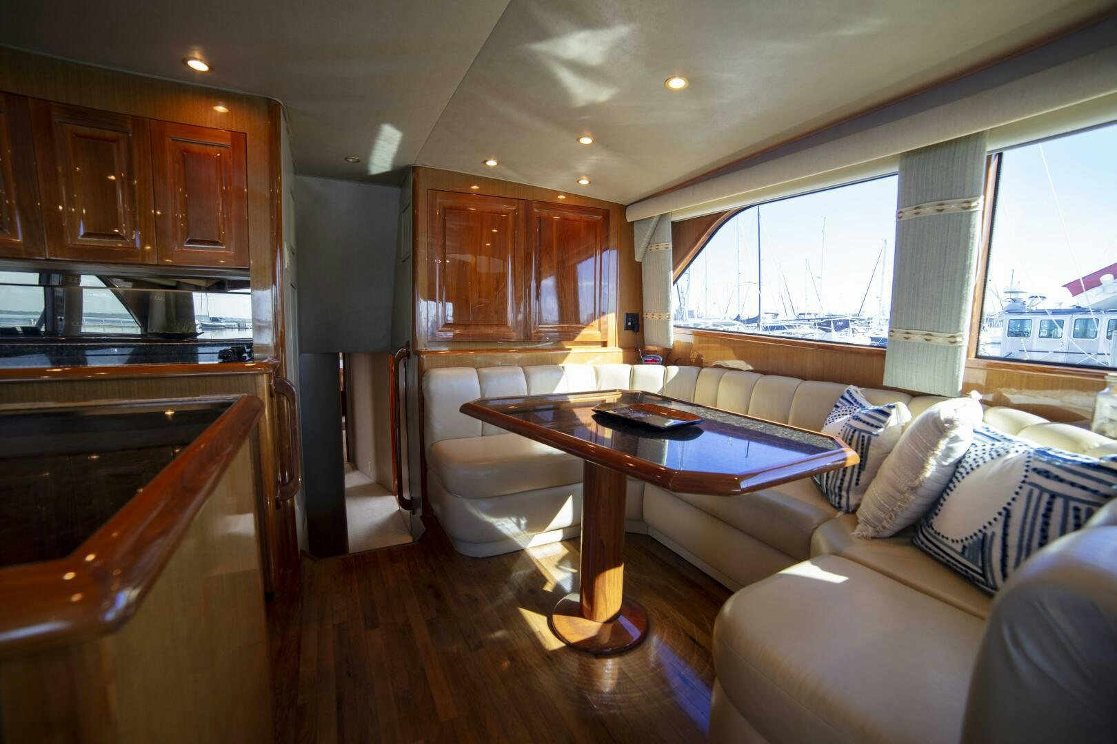 a living room with a table and couches aboard PRIME TIME Yacht for Sale
