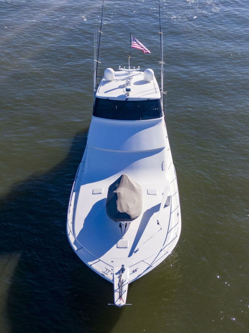 a boat with a flag on it aboard PRIME TIME Yacht for Sale