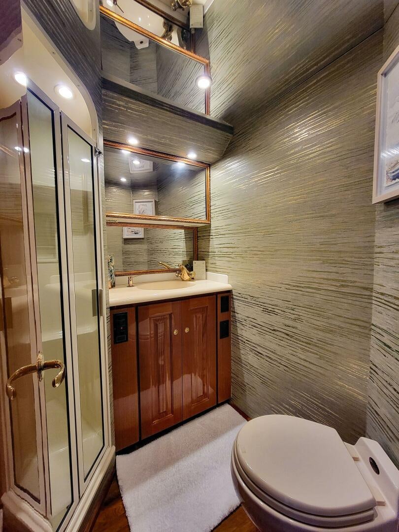 a bathroom with a glass shower door aboard PRIME TIME Yacht for Sale