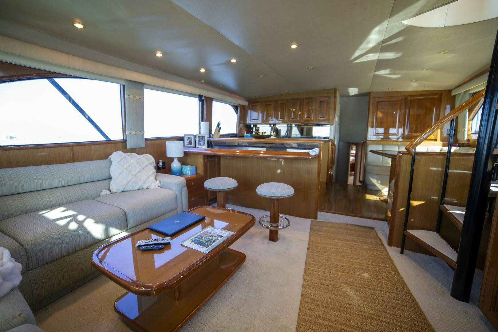 a living room with a couch and a table aboard PRIME TIME Yacht for Sale