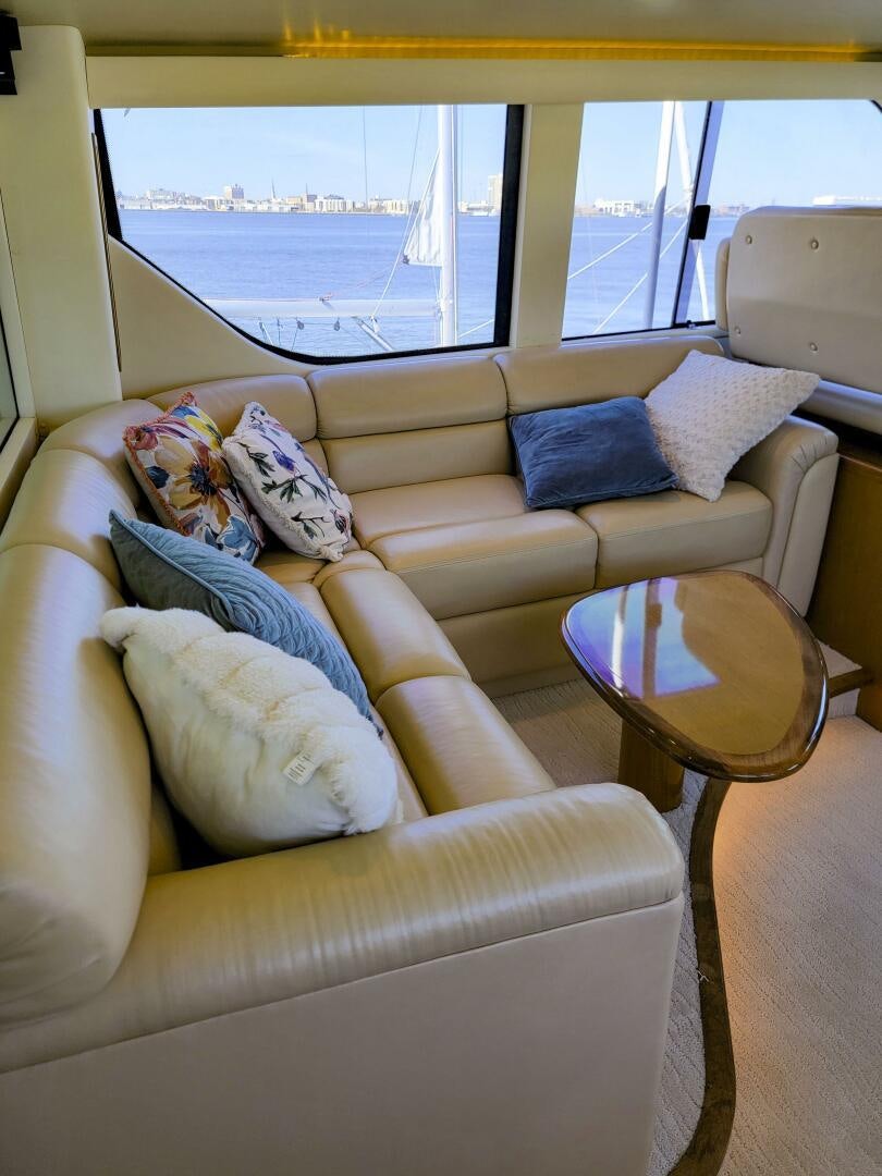 a couch with pillows on it aboard PRIME TIME Yacht for Sale