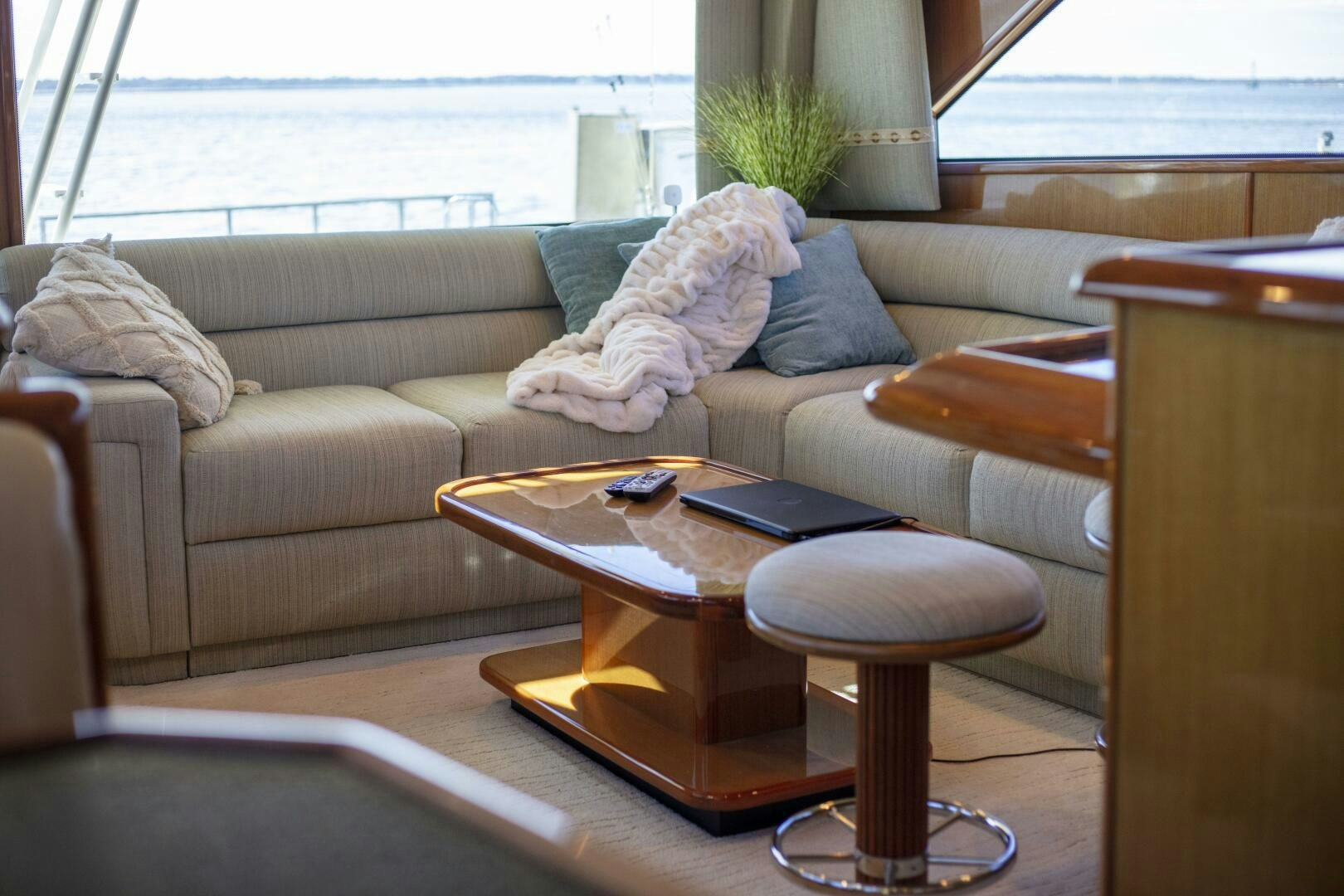 a couch with a coffee table aboard PRIME TIME Yacht for Sale