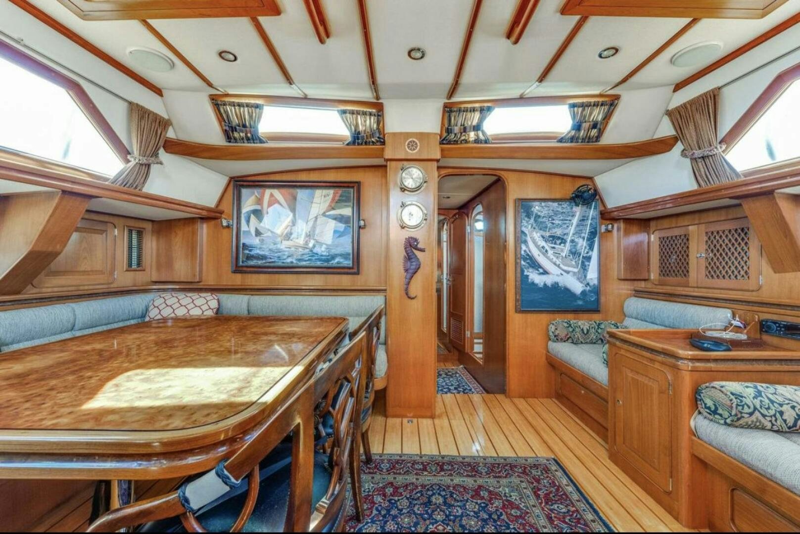 a room with a table and chairs aboard PERFECT SYMMETRY 5 Yacht for Sale