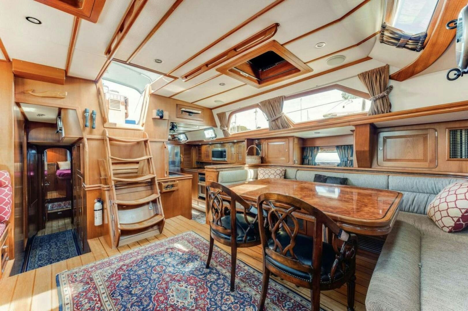 a large dining table in a living room aboard PERFECT SYMMETRY 5 Yacht for Sale