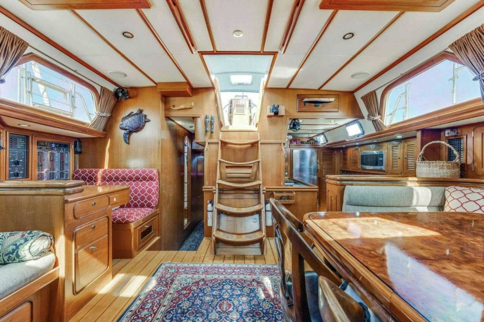 a room with a table and chairs aboard PERFECT SYMMETRY 5 Yacht for Sale