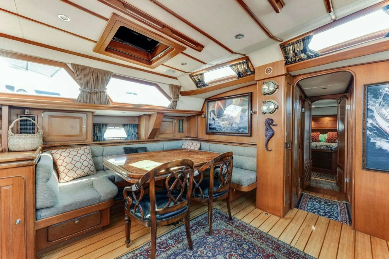 a living room with a table and chairs aboard PERFECT SYMMETRY 5 Yacht for Sale