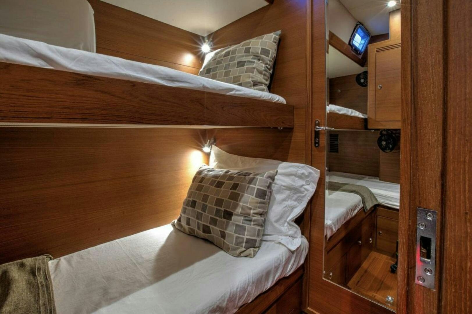 a bed with a wood headboard aboard RAGNAR Yacht for Sale