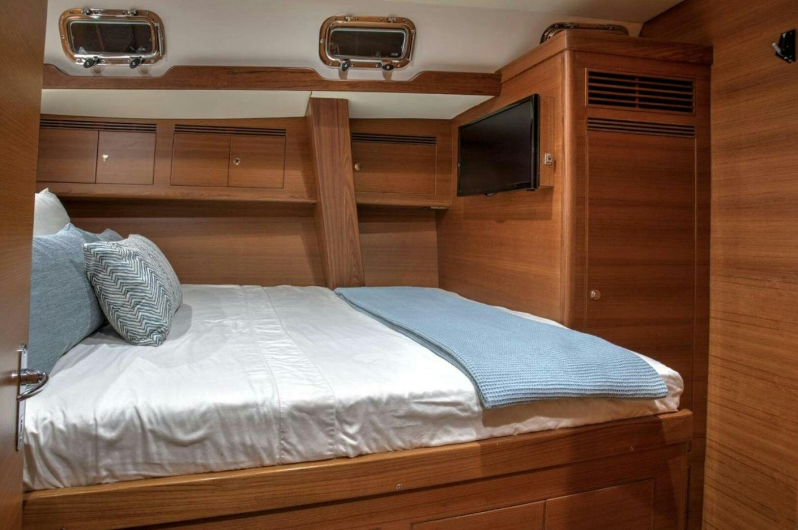 a bed with a white sheet and pillows aboard RAGNAR Yacht for Sale