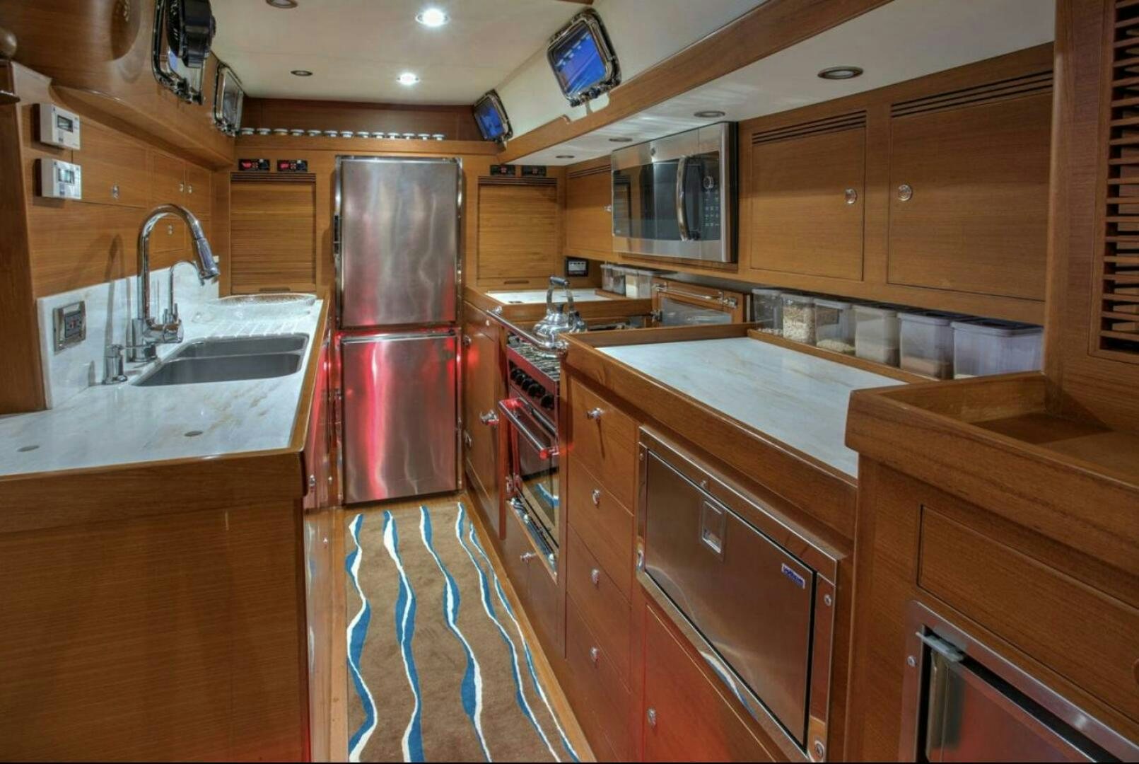 a kitchen with wooden cabinets aboard RAGNAR Yacht for Sale