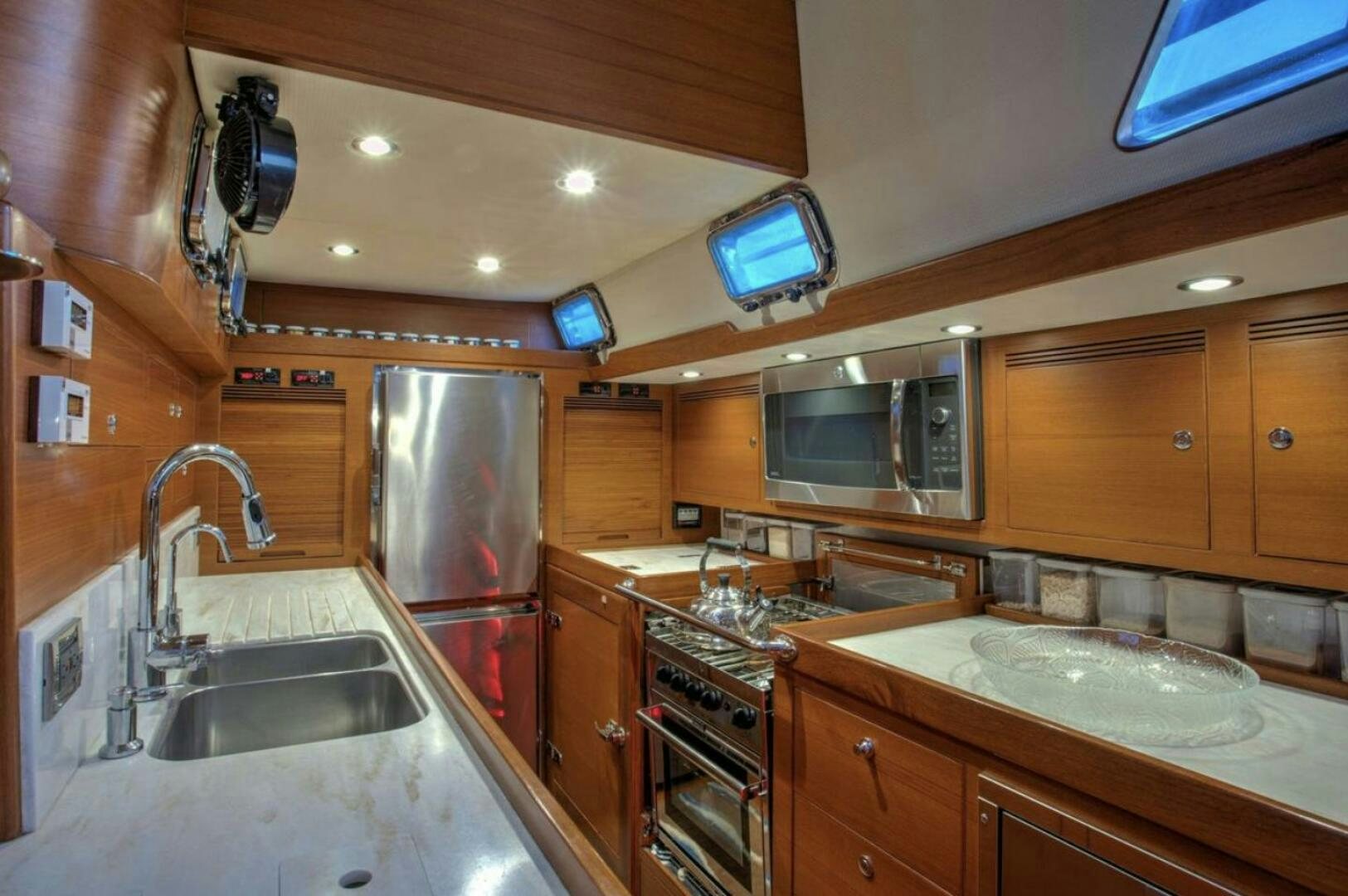 a kitchen with wooden cabinets aboard RAGNAR Yacht for Sale