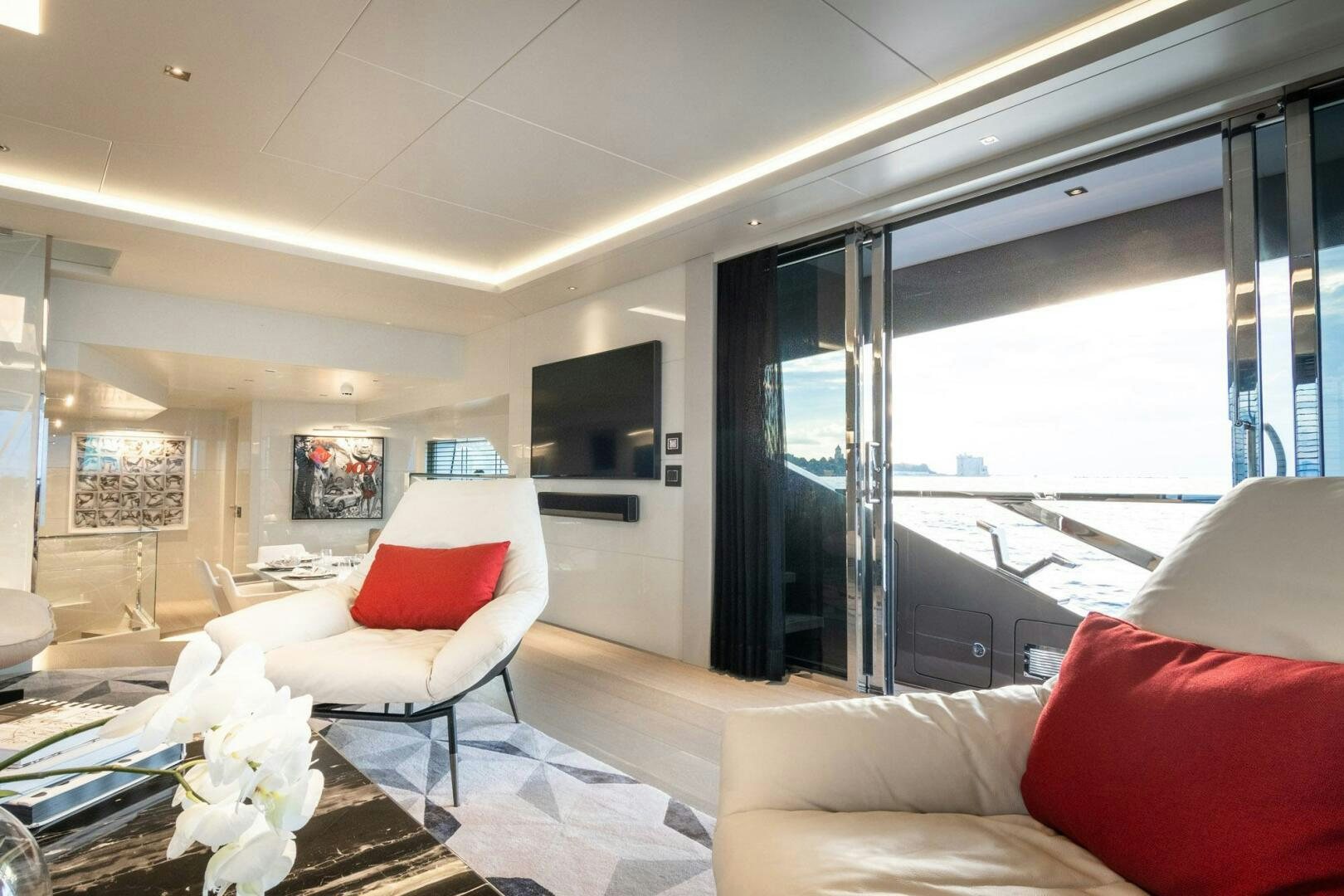 a living room with a large window aboard BEACH CLUB Yacht for Sale