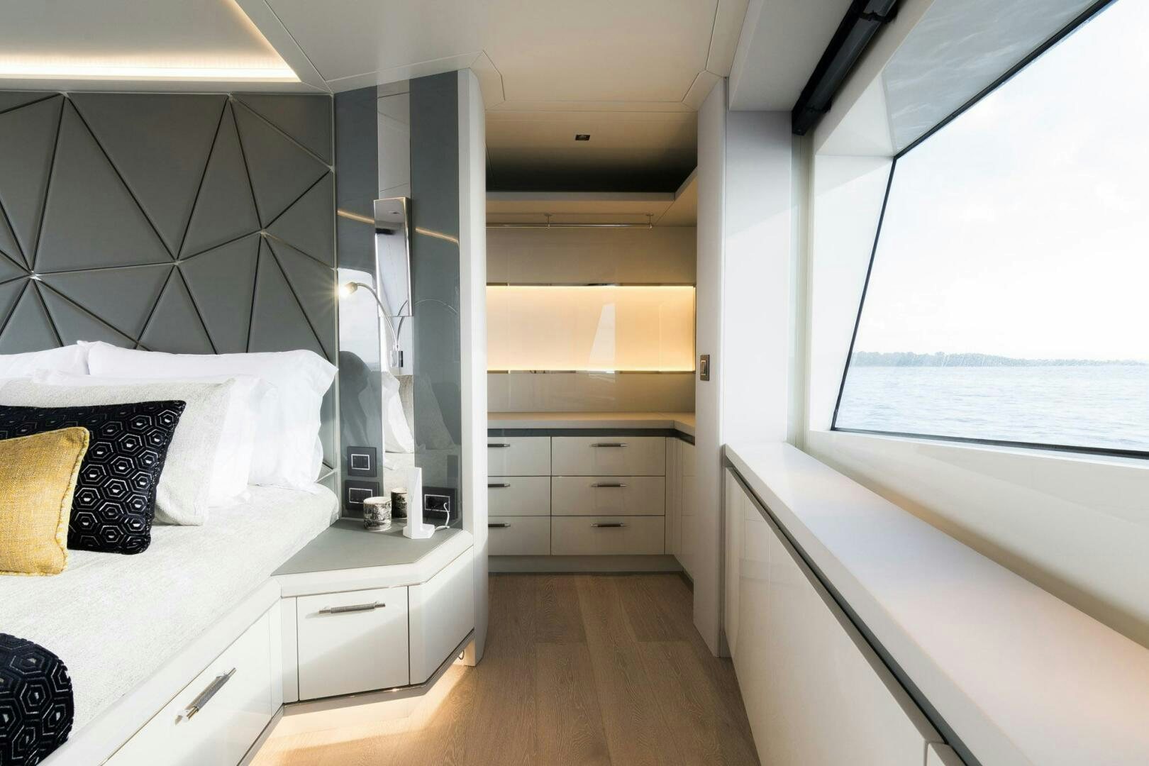 a bedroom with a bed and a window aboard BEACH CLUB Yacht for Sale