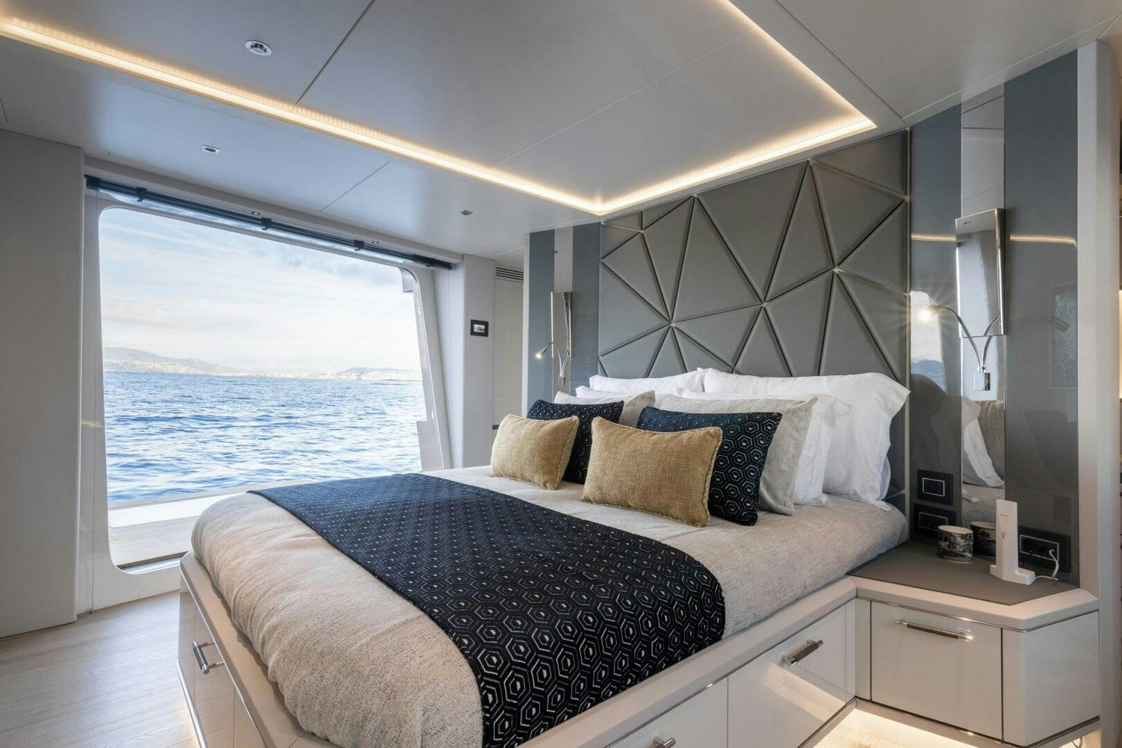 a bed with a large window aboard BEACH CLUB Yacht for Sale